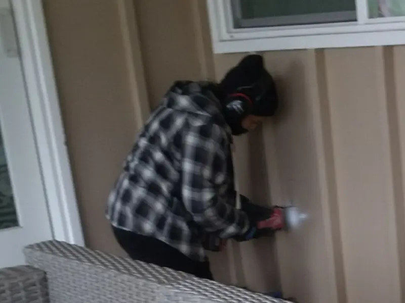 Professional electrician installing an exterior outlet in Trinity